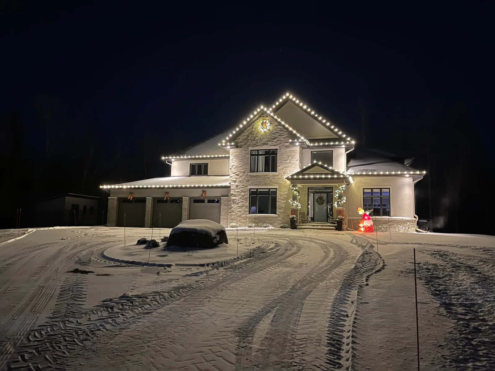 Residential holiday lighting installation lighting up the front of a home